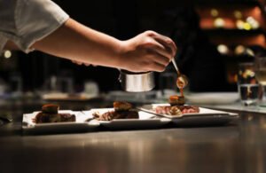teppanyaki chef cooking in front of guests.