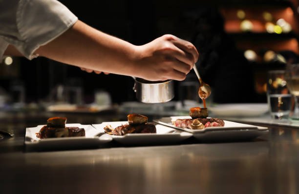 From Casual Dinner to Private Dining: Making Every Seafood Meal Special teppanyaki chef cooking in front of guests.